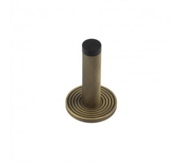 Burlington Knurled Wall Mounted Door Stop On Reeded Rose - Antique Brass