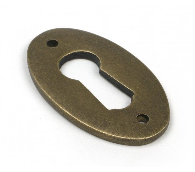 From The Anvil 52455 Oval Standard Keyhole Escutcheon - Burnished Brass