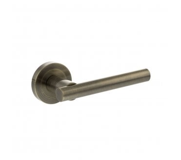 STATUS Nebraska Lever Door Handle on Round Rose - Antique Brass
